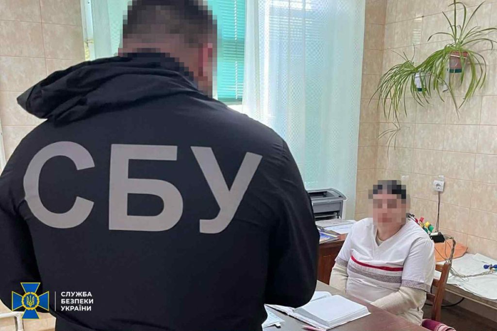 На фото - працівник СБУ під час обшуку